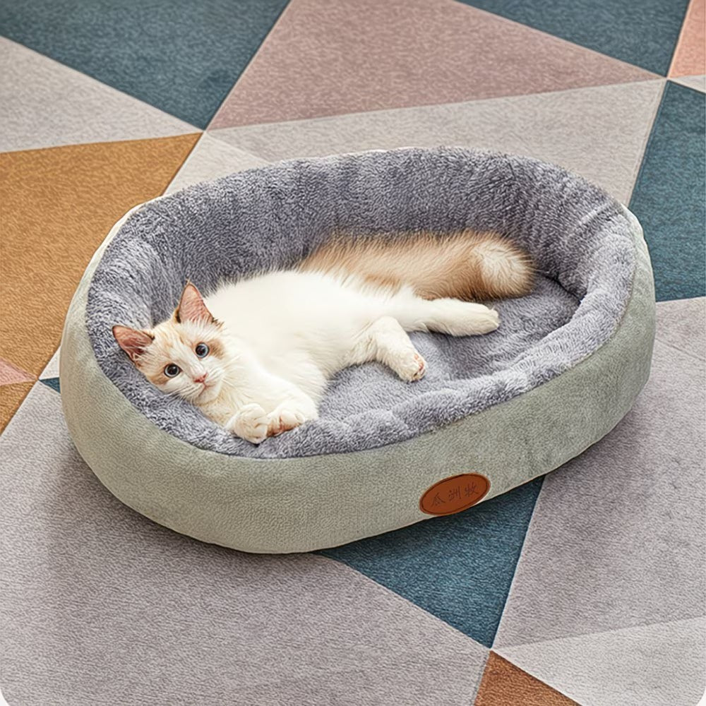 Cama ovalada para mascotas con bordes elevados y revestimiento interior