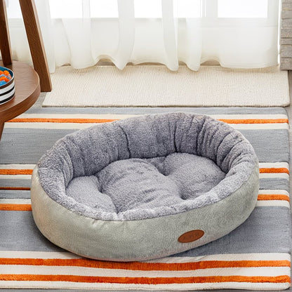 Cama ovalada para mascotas con bordes elevados y revestimiento interior